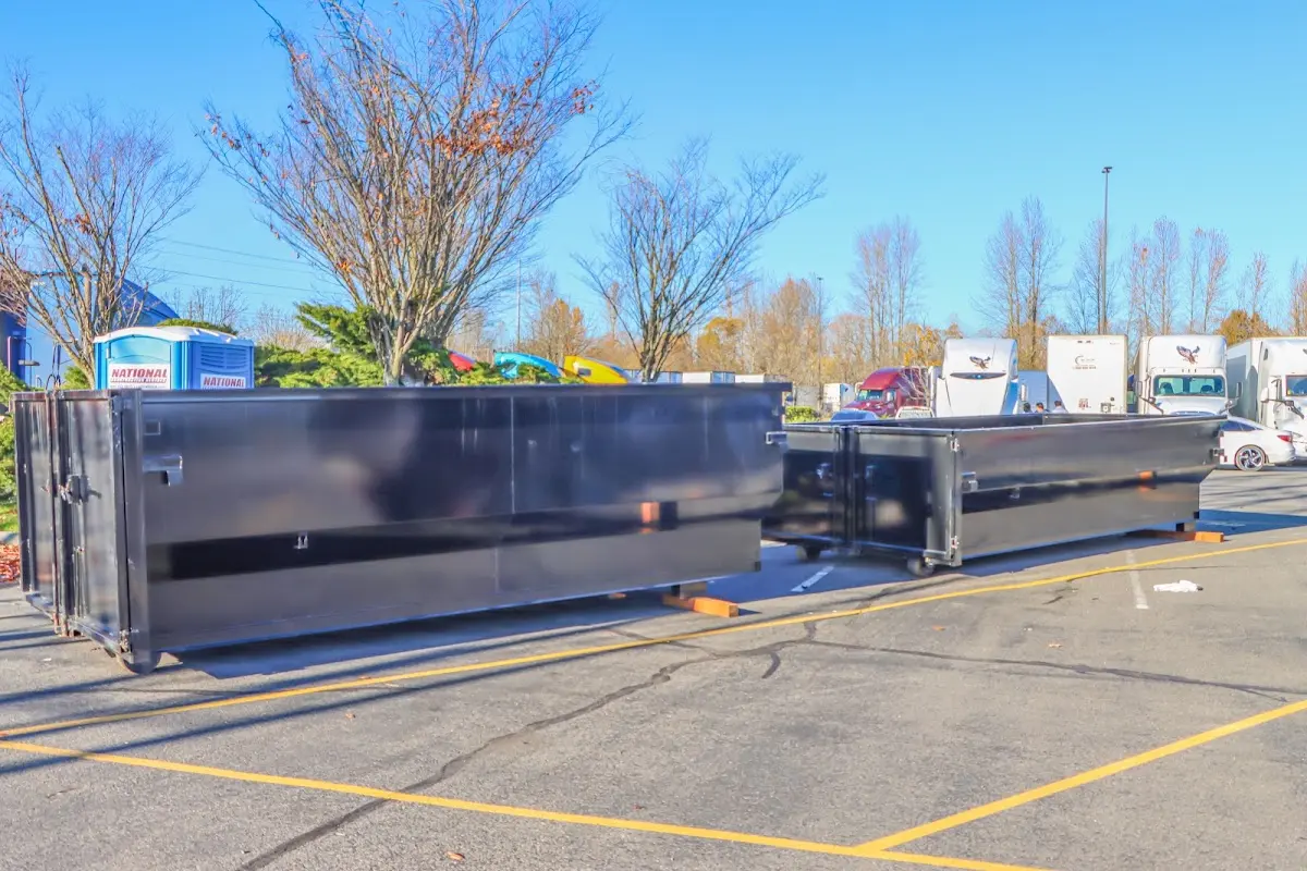Professional dumpster rental service with roll-off container on residential driveway in Cedar City